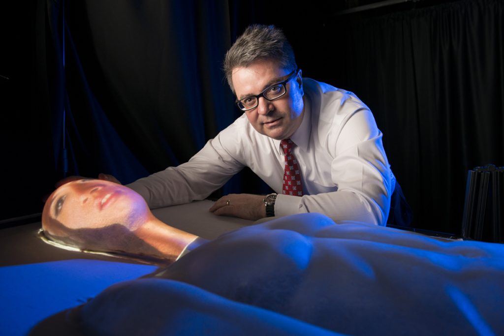 Greg Welch and prototype of an adult physical-virtual patient bed (PVPB).