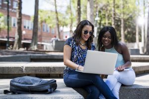 Online students sitting outside