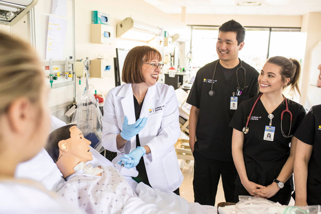 UCF College of Nursing faculty member Erica Hoyt instructing BSN students in the STIM Center (healthcare simulation lab).