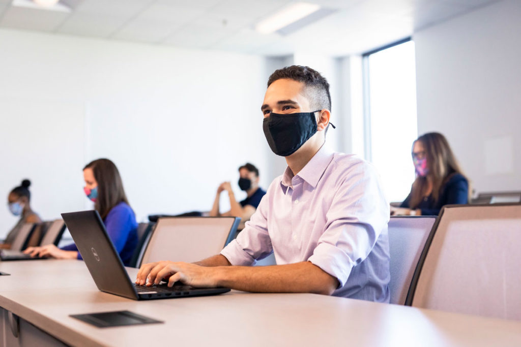 UCF classroom with students wearing masks and sitting socially distanced.