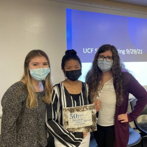 Three Student Nurses' Association at UCF Orlando student leaders holding a certificate