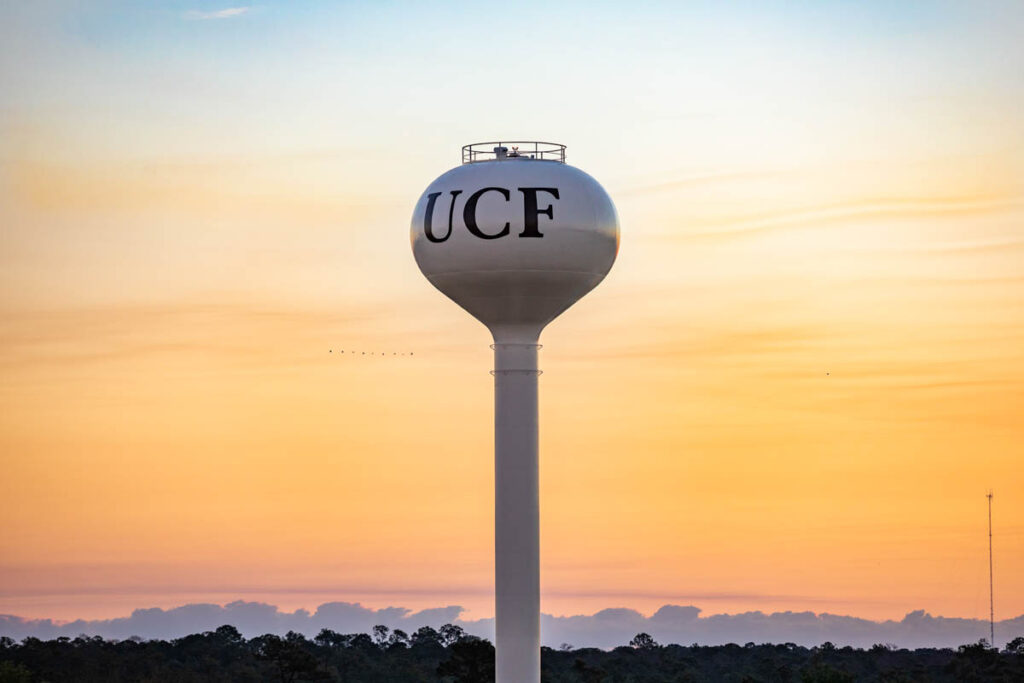 The sun rises over the UCF campus water tower