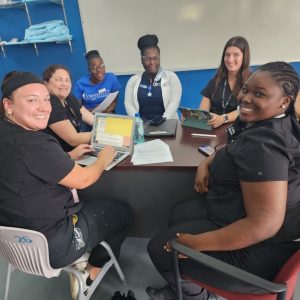 A group of UCF College of Nursing students collaborating with nursing students at The University of The Bahamas.