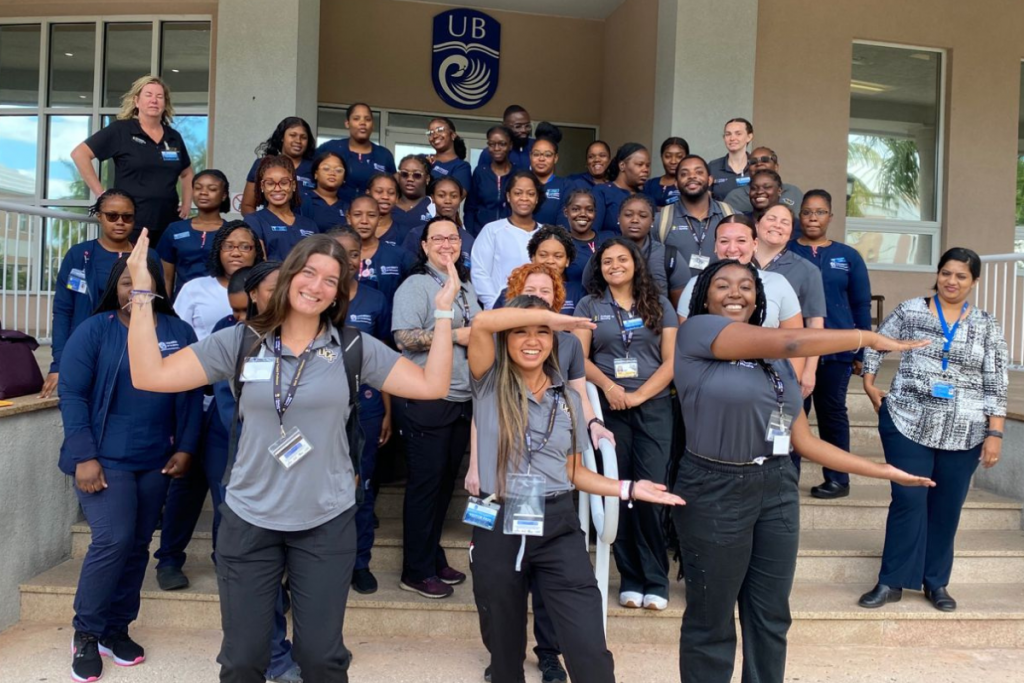 UCF College of Nursing students spell out "UCF" in front of a group of students and faculty from UCF and the University of The Bahamas