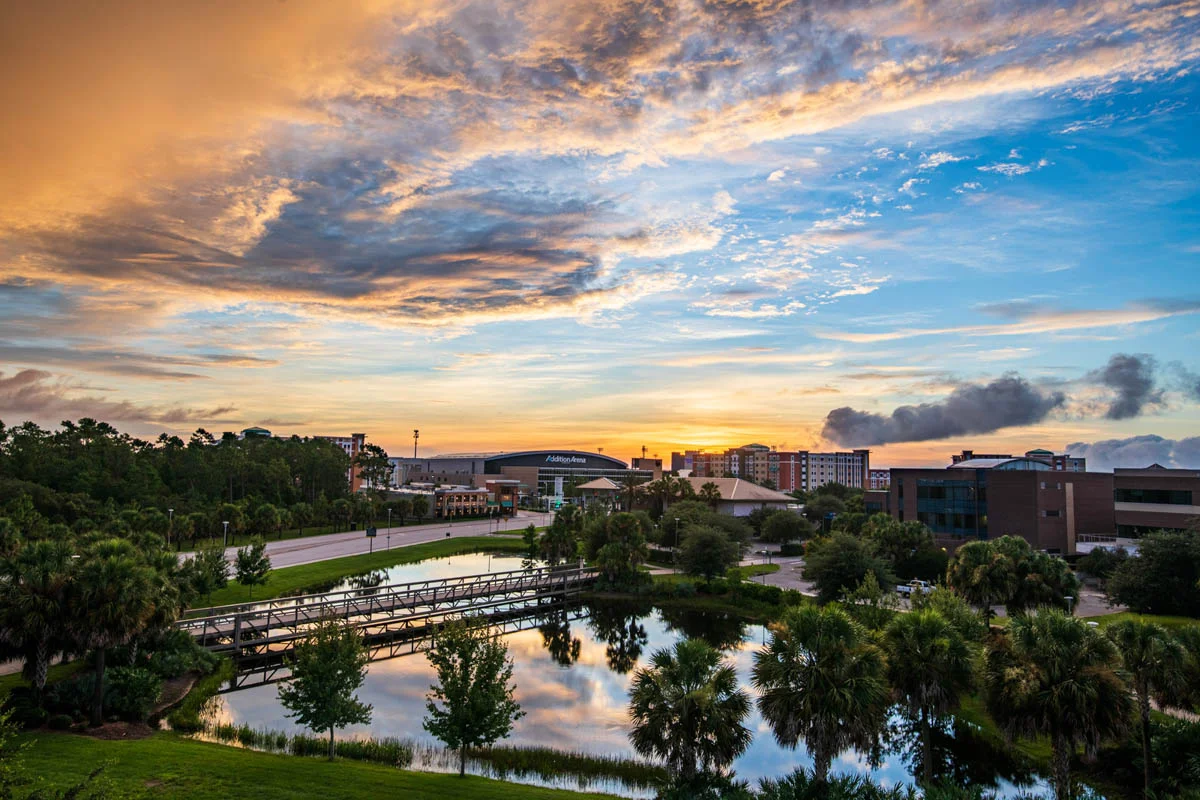 The sun rises above Addition Financial Arena on the UCF campus in Orlando, Florida