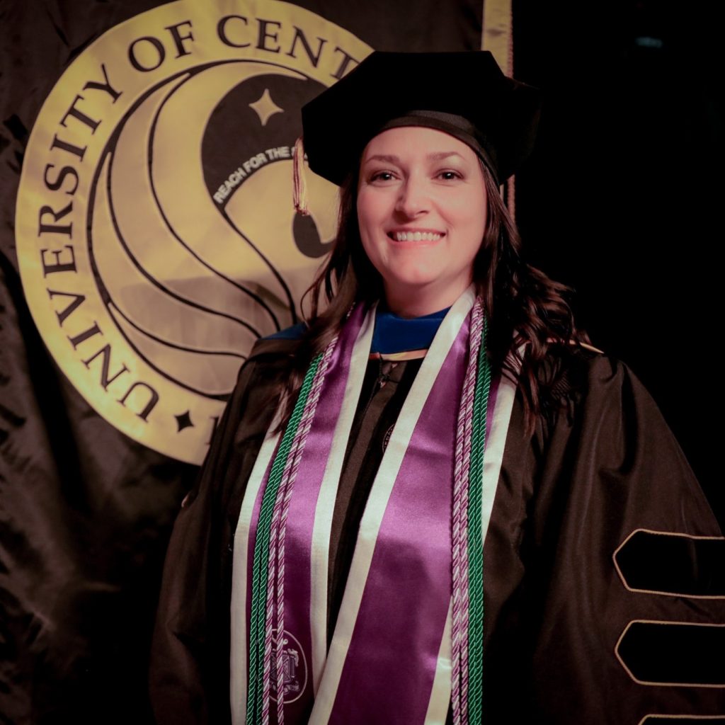 Jenna Wheeler ’07 ’11BSN '23PhD, in regalia at the Summer 2023 UCF College of Nursing recognition ceremony