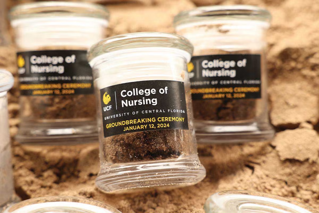 Small jars of dirt with labels from UCF College of Nursing Groundbreaking Ceremony