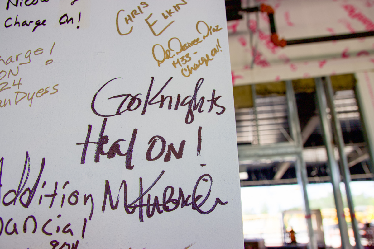 Signatures and messages to future nursing students on a white steel structural beam inside the Dr. Phillips Nursing Pavilion, which is under construction in Lake Nona.