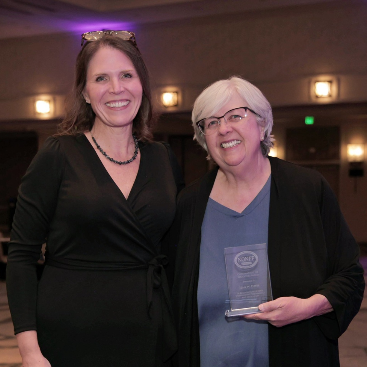 Jean Davis, on right, holds a crystal award and stands next to Dr. Shannon Idzik, president of the National Organization of Nurse Practitioner Faculties.