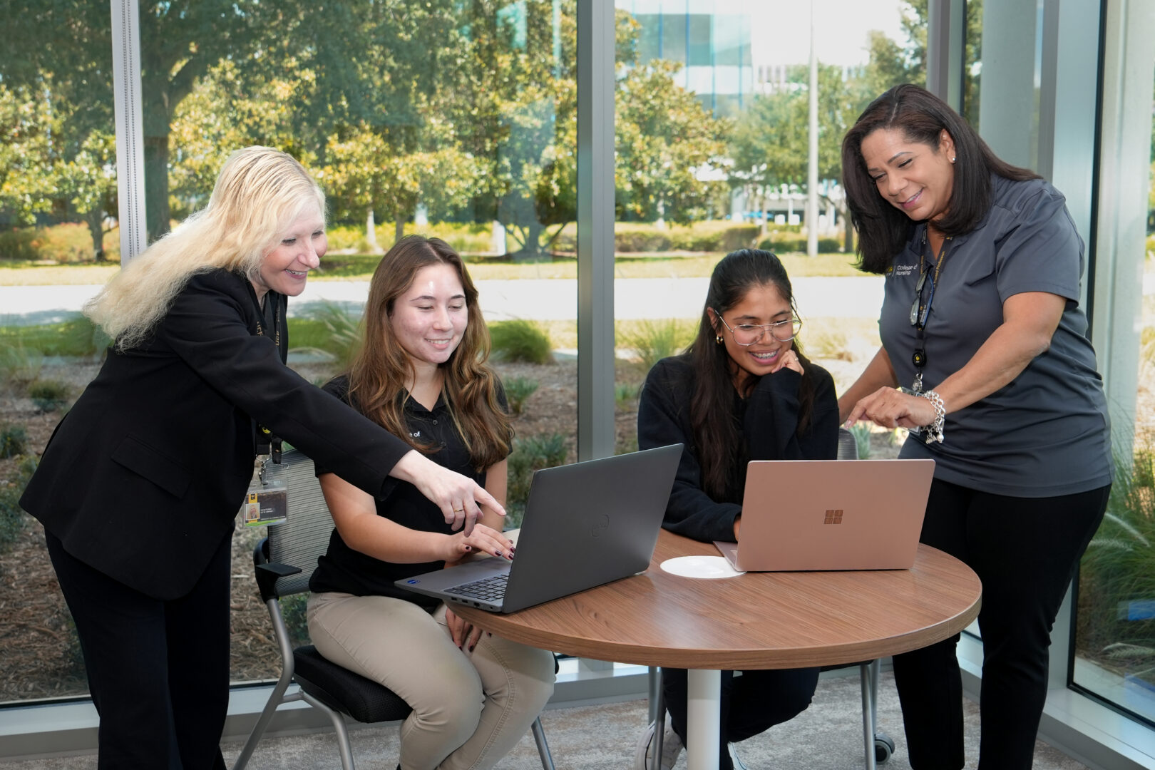 Donna and Leighann helping students that are on a laptop.