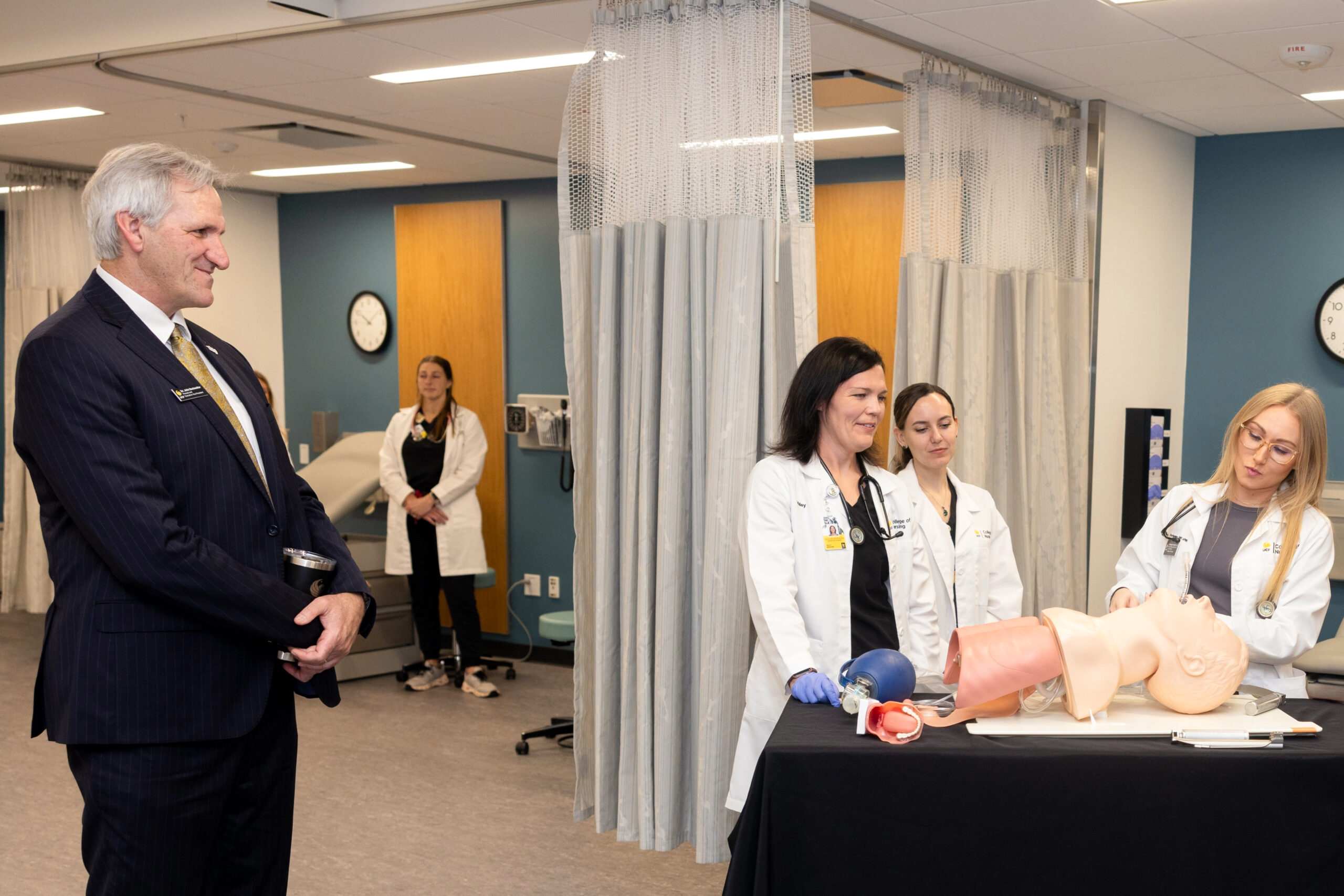 UCF College of Nursing faculty and nurse practitioner graduate students demonstrate simulation learning with UCF Provost John Buckwalter.