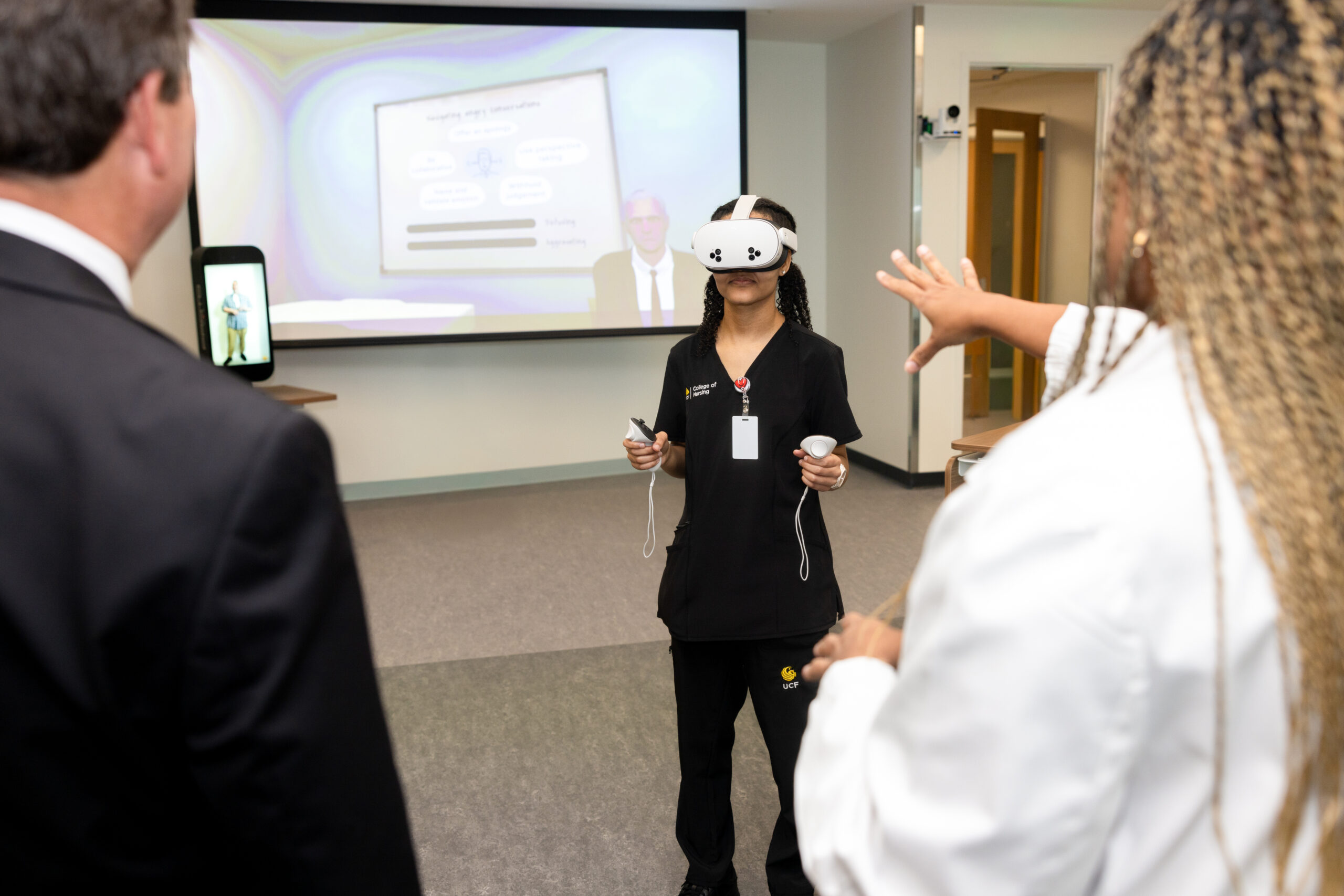 A UCF student wearing a VR headset in the Dr. Colleen Conway-Welch Virtual Reality Learning Studio