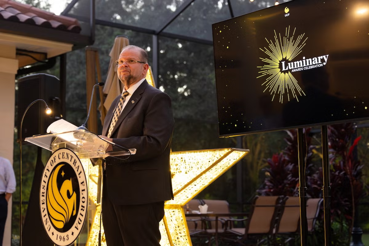 UCF President Alexander Cartwright speaks at a podium during the 2025 Luminary Awards