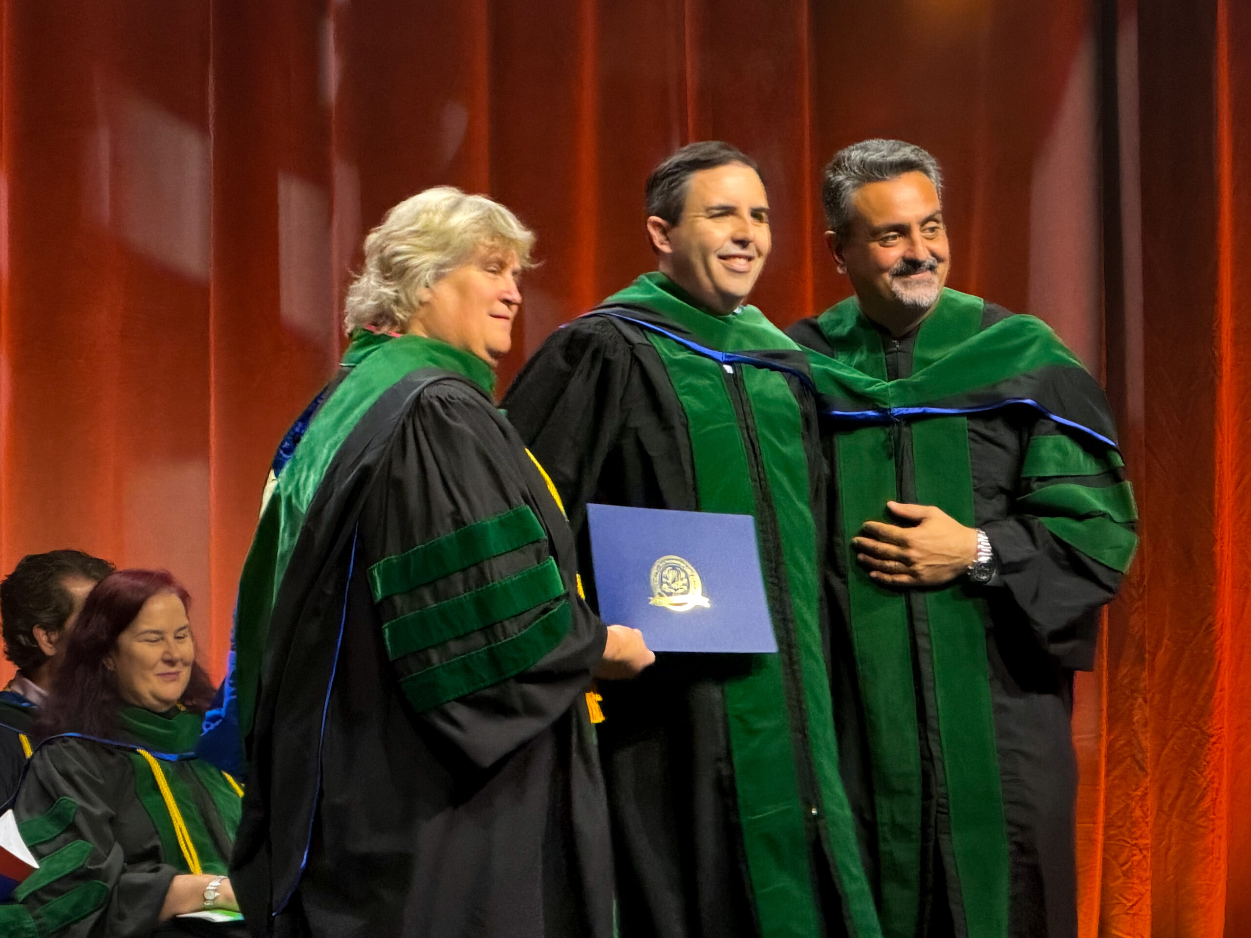 UCF Nursing Associate Professor Brian Peach onstage during the induction ceremony for the American College of Critical Care Medicine.