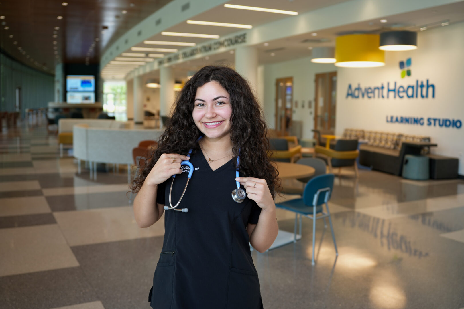 A Knight nurse holding a stethoscope around her neck.