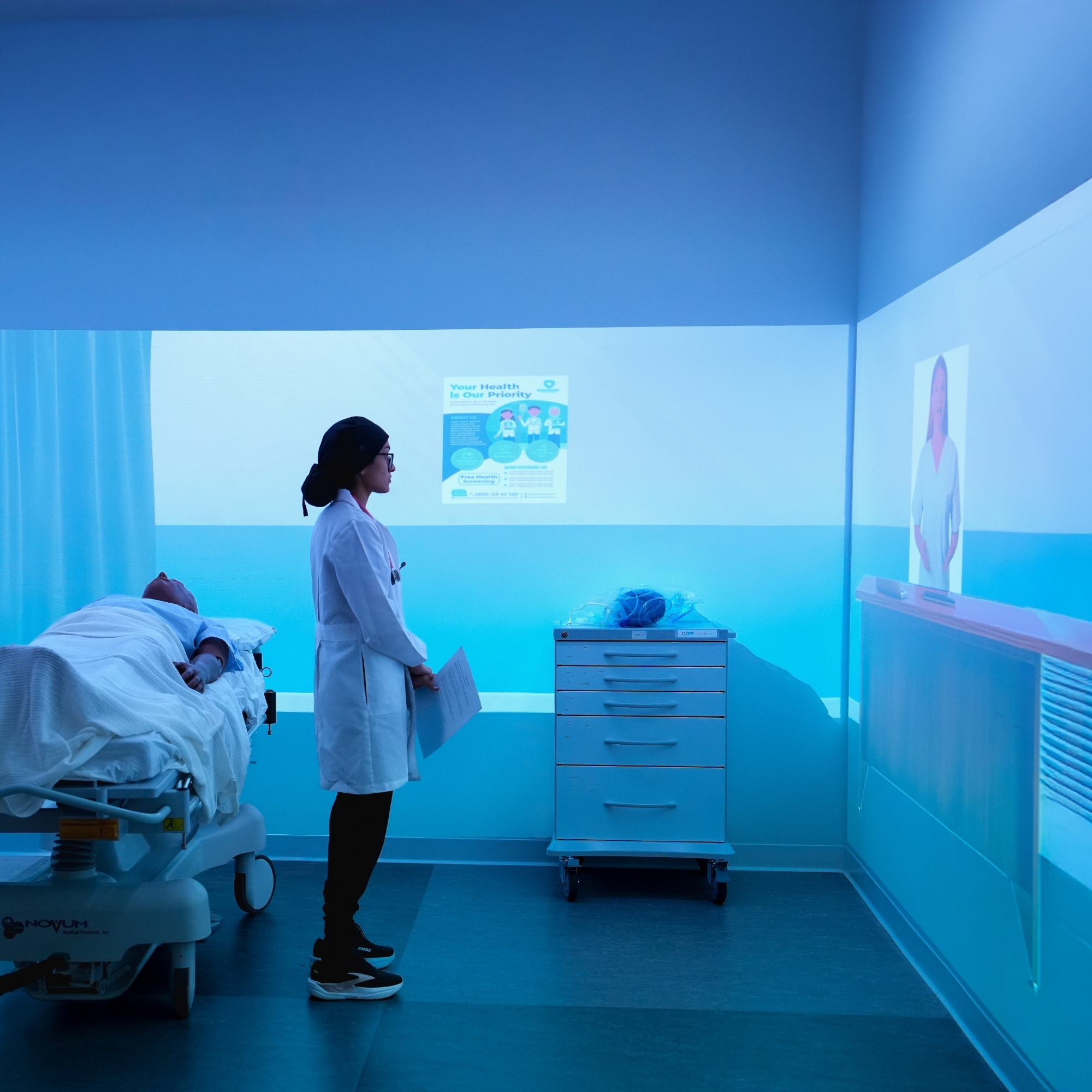 A student looking at an avatar in the VR Cave.